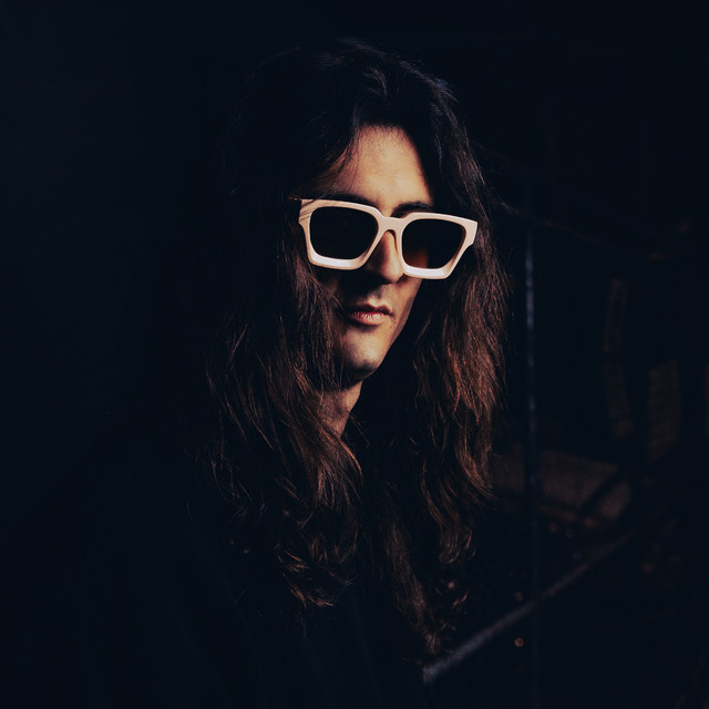 Louie Dager, house and tech house DJ, in white sunglasses